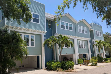 Freshly painted stucco home in tampa fl with bright white trim under sunny skies